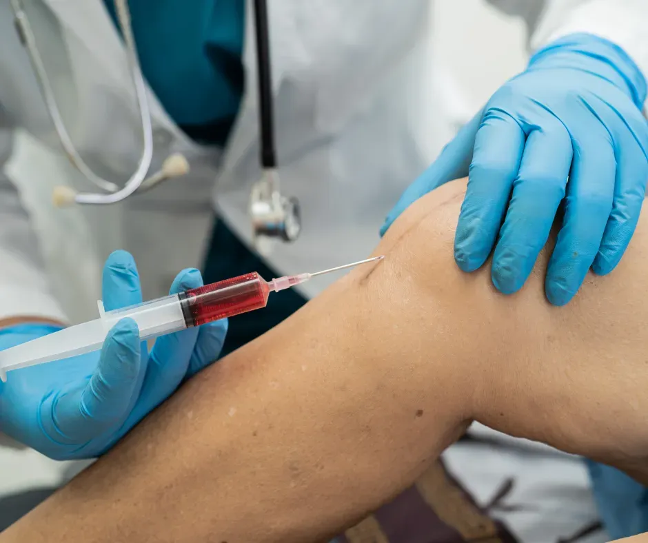 Healthcare professional administering stem cell injection into a patient's knee joint